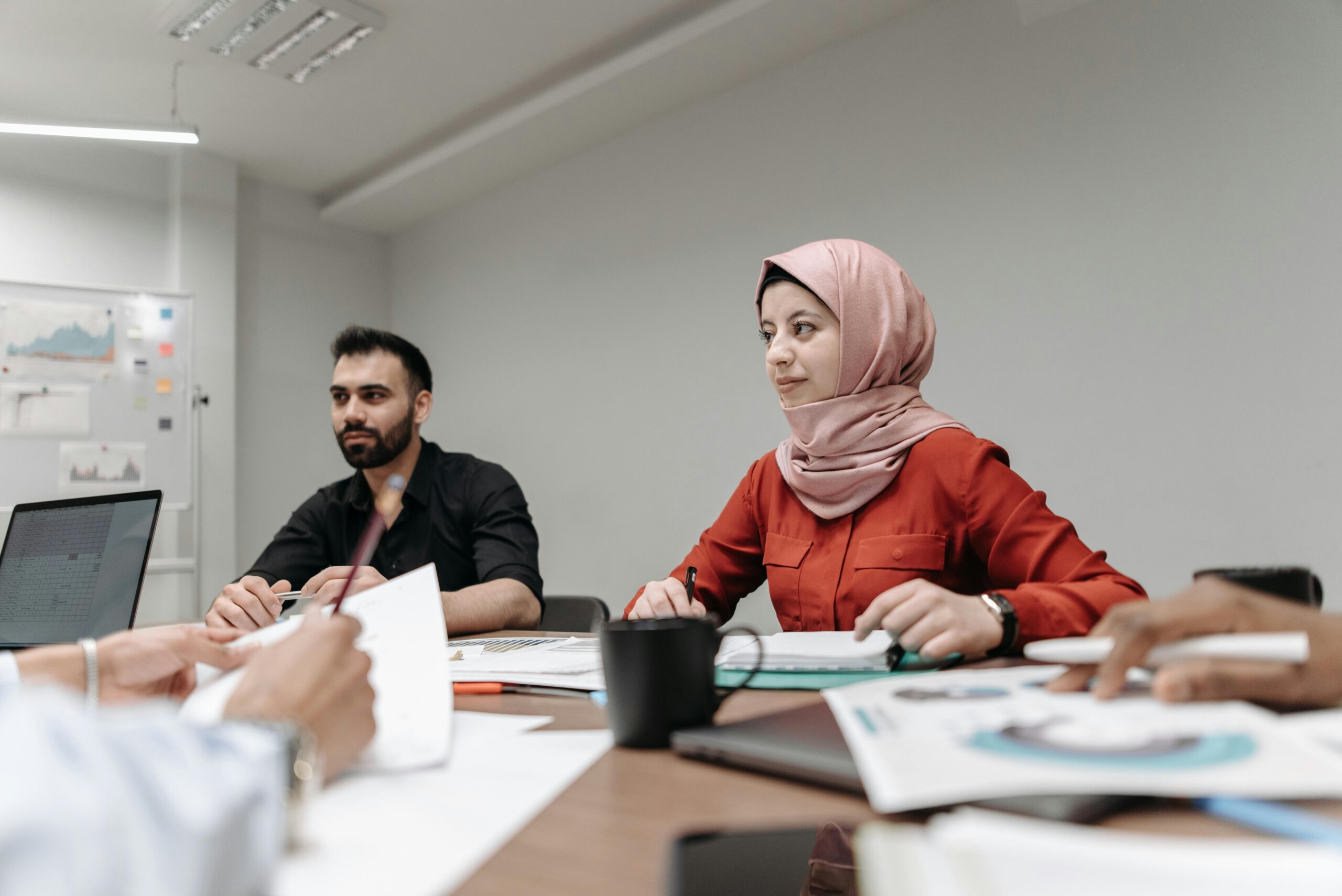 Team of diverse professionals engaged in an indoor business meeting at the office.